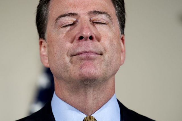 FBI Director James Comey pauses while making a statement at FBI Headquarters in Washington, Tuesday, July 5, 2016. Comey said the FBI will not recommend criminal charges in its investigation into Hillary Clinton's use of a private email server while secretary of state. (AP Photo/Cliff Owen)