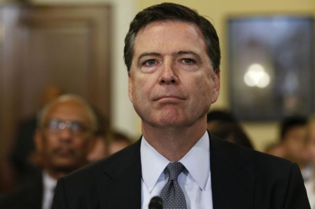 FBI Director James B. Comey listens to a question from a reporter during a media conference in San Francisco, Calif., Feb. 27, 2014. (Photo by Ben Margot/AP)